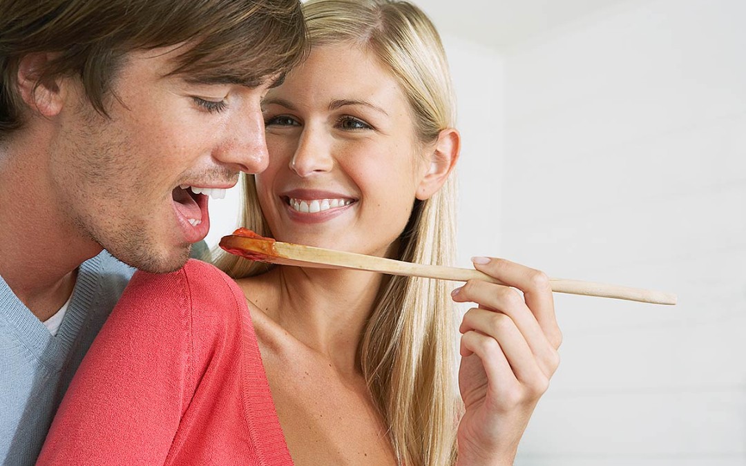 Couple cooking and eating healthy food